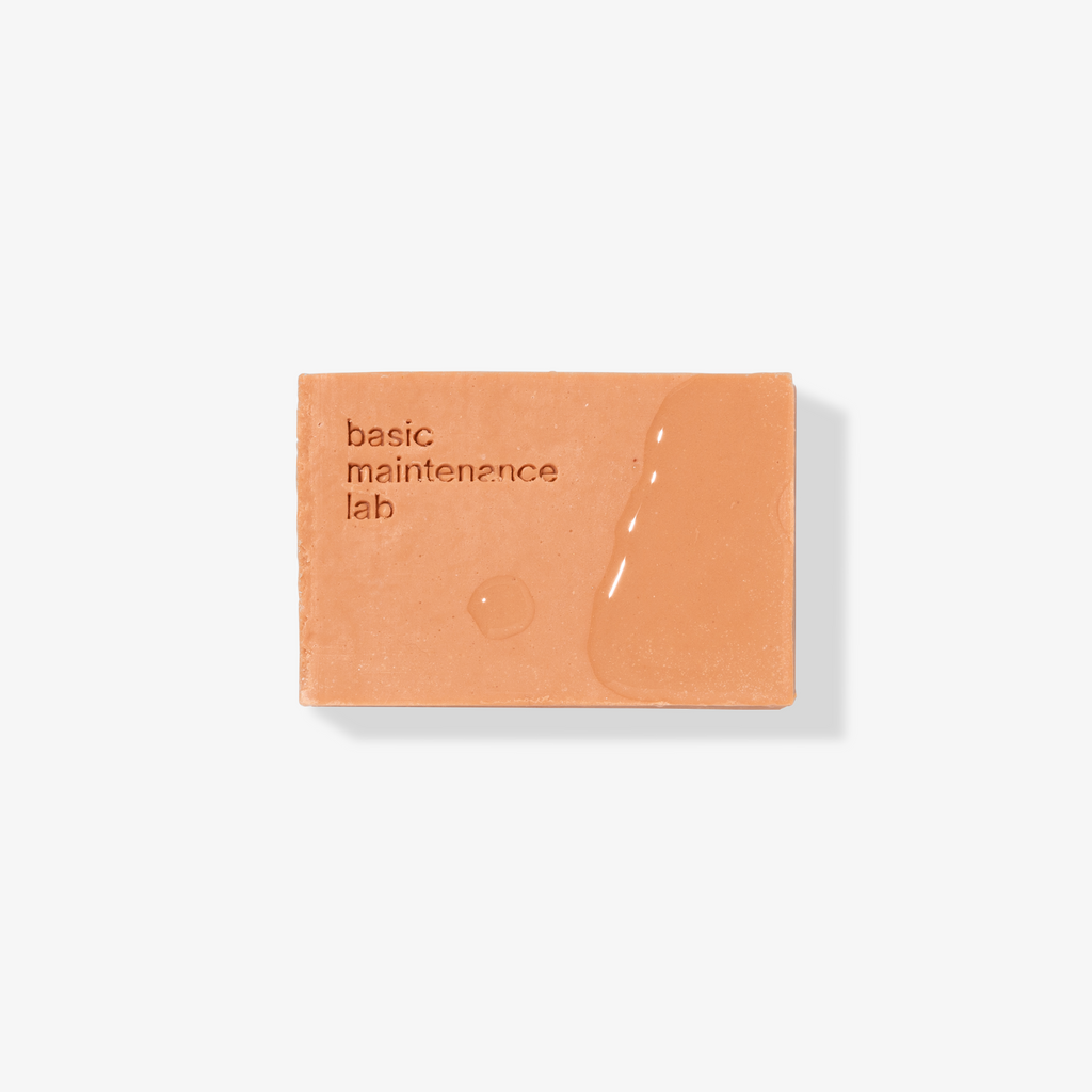 Basic Maintenance Formula 10 The Cleansing Clay shown as a orange bar of soap