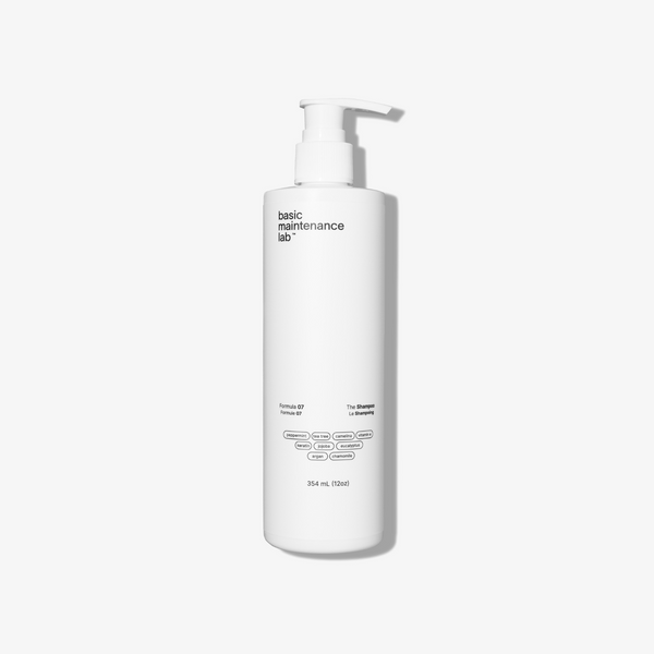 Basic Maintenance Formula 07 The Shampoo shown in a white cylinder bottle with a pump cap